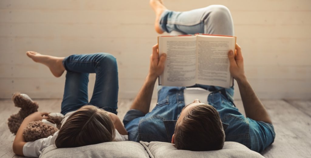 Vater liest seiner Tochter aus einem Buch vor