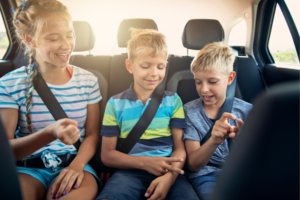 Drei Kinder auf der Rückbank eines Autos
